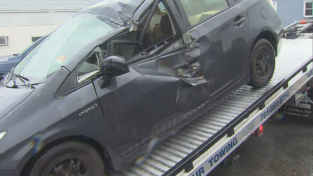 damaged vehicle on a tow truck