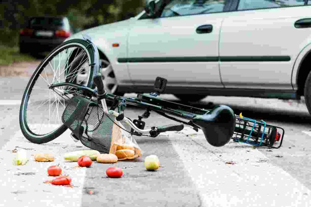 bike with basket of groceries crashed into a car