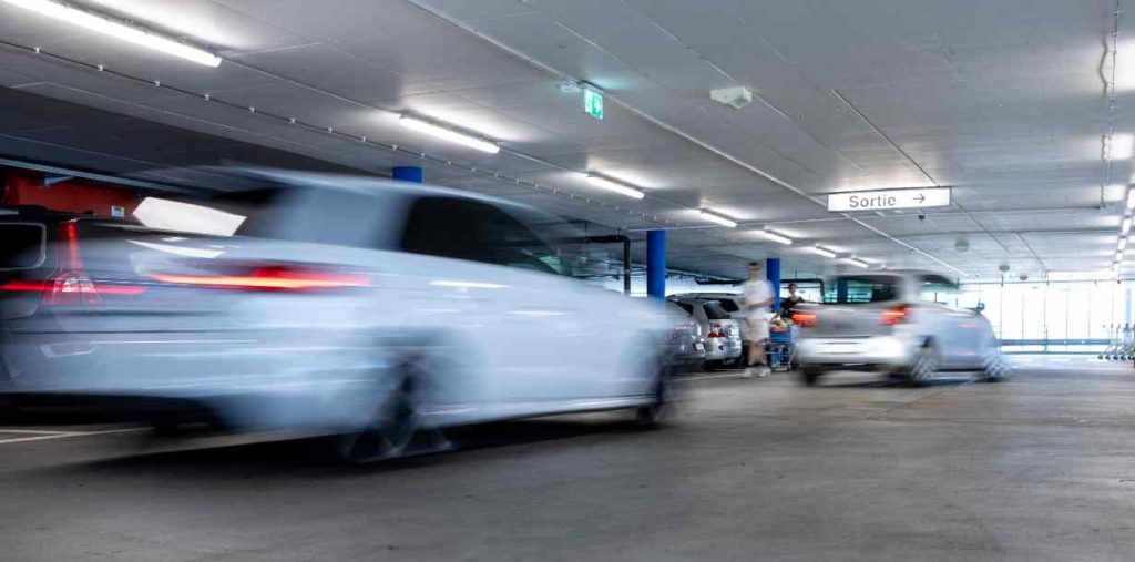 speeding cars in a parking garage