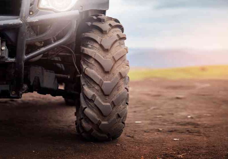 Front of an ATV on dirt path