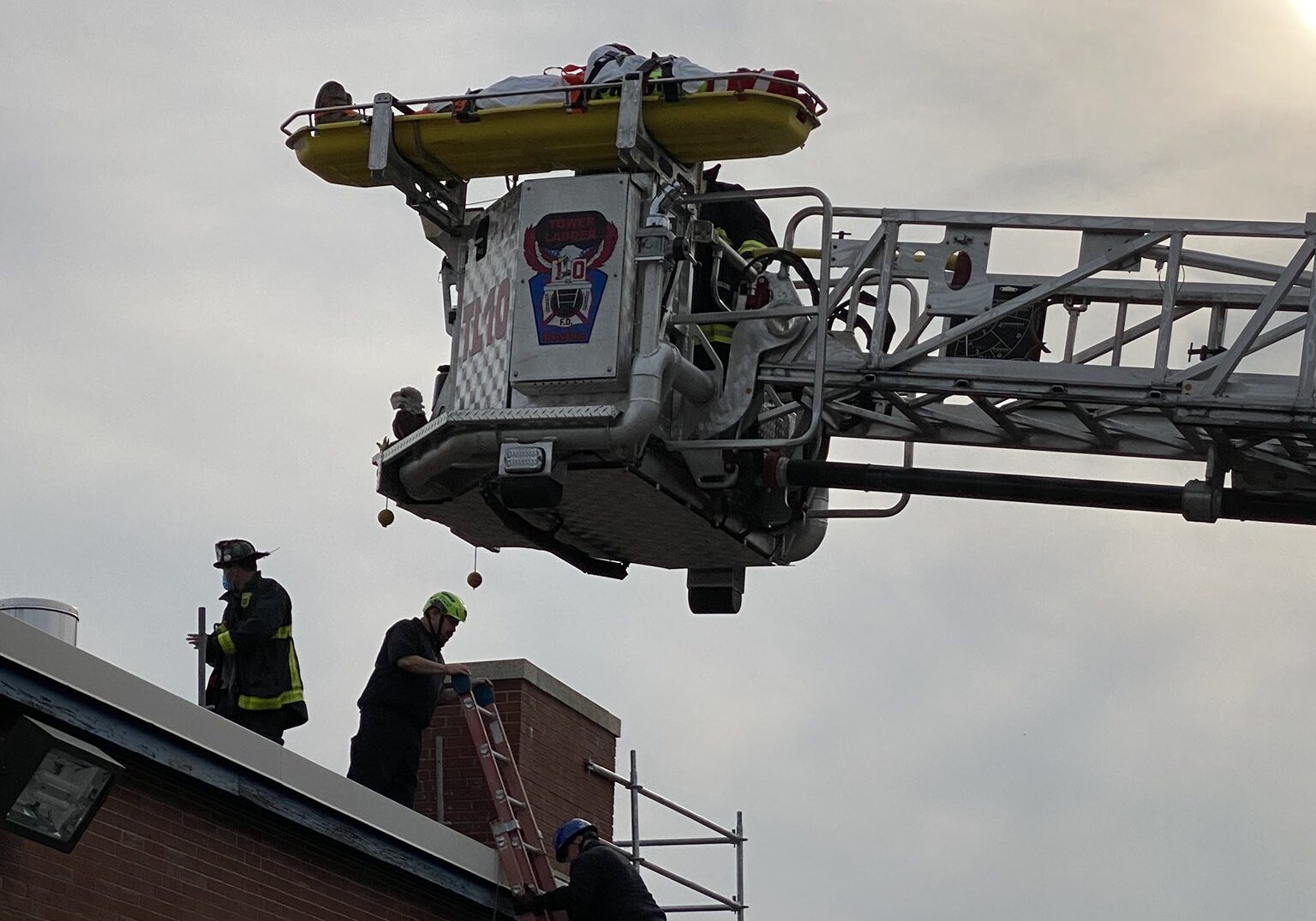 Crane carrying victim out of the top of a building
