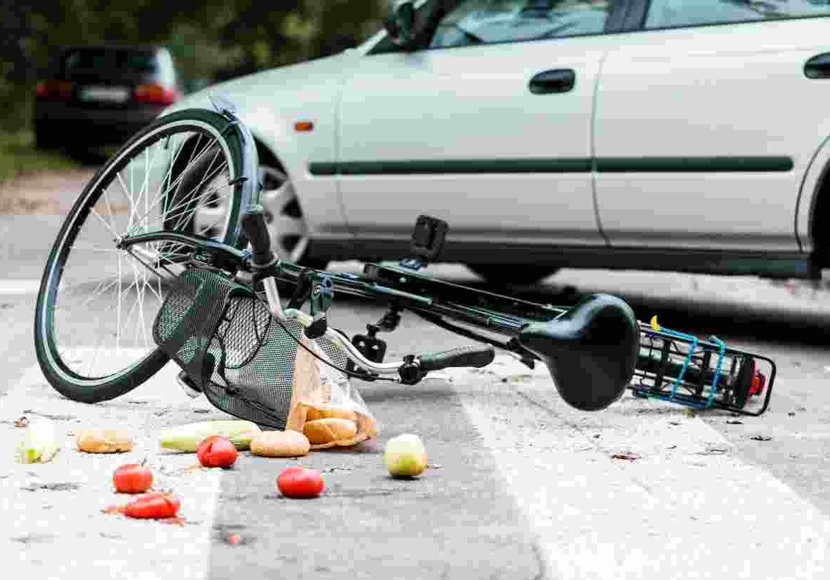 bike with basket of groceries crashed into a car
